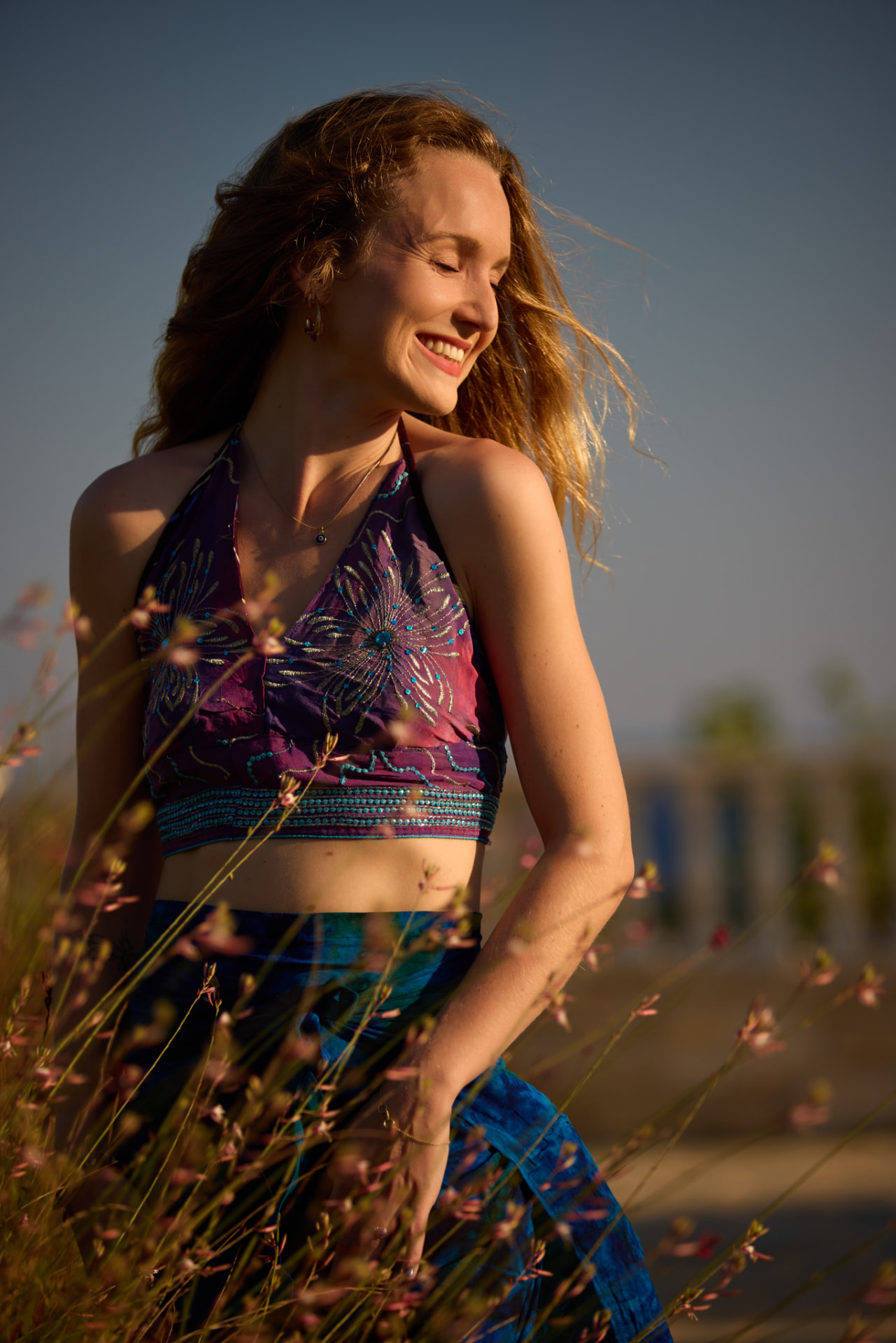 Elise laughing outdoors in the last of the evening light